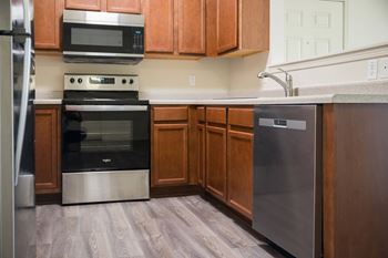 A kitchen with wooden cabinets and stainless steel appliances.